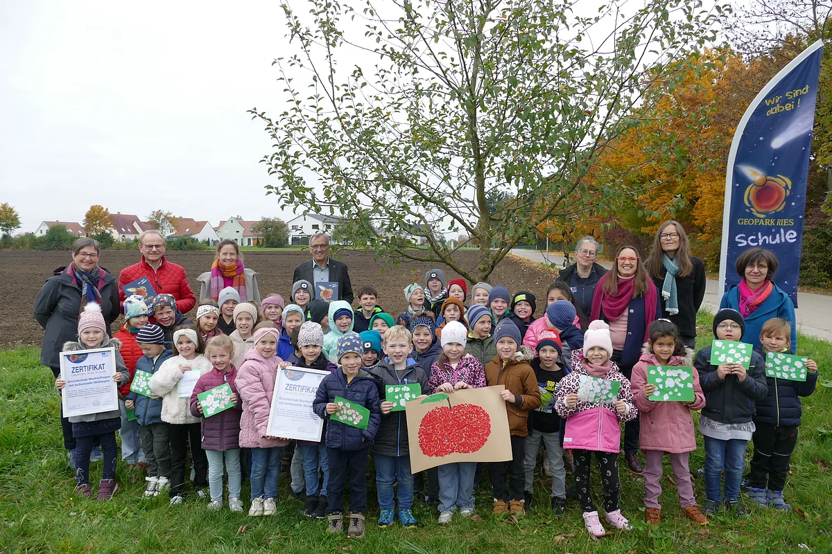 Auf dem Bild sieht man die Schülerinnen und Schüler der Klassen 1 und 2 der Grundschule Marktoffingen- Maihingen mit der Urkunde Geopark Ries Schule