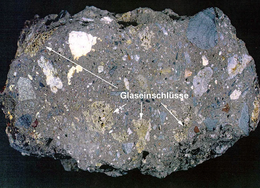 Foto eines typischen Suevit-Gesteins mit verschiedenfarbigen Einschlüssen und Glaseinschlüssen (Bosumtwi-Krater, Ghana)
